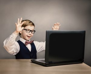 Child With Laptop, Little Boy In Glasses Happy Amazed Looking At