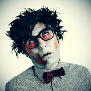a hipster zombie wearing a bow tie and glasses